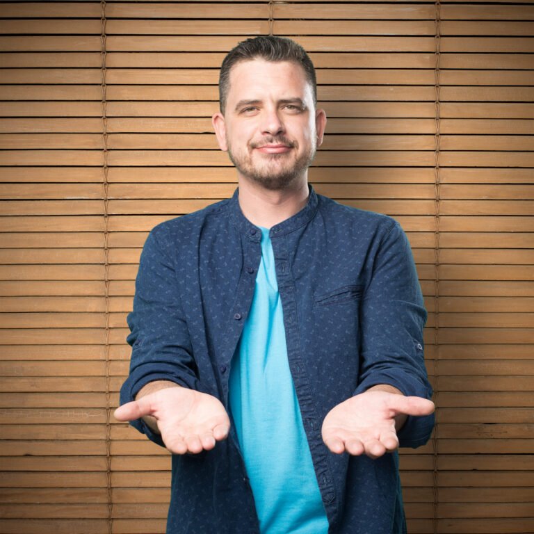Young man wearing a blue outfit. Holding gesture.